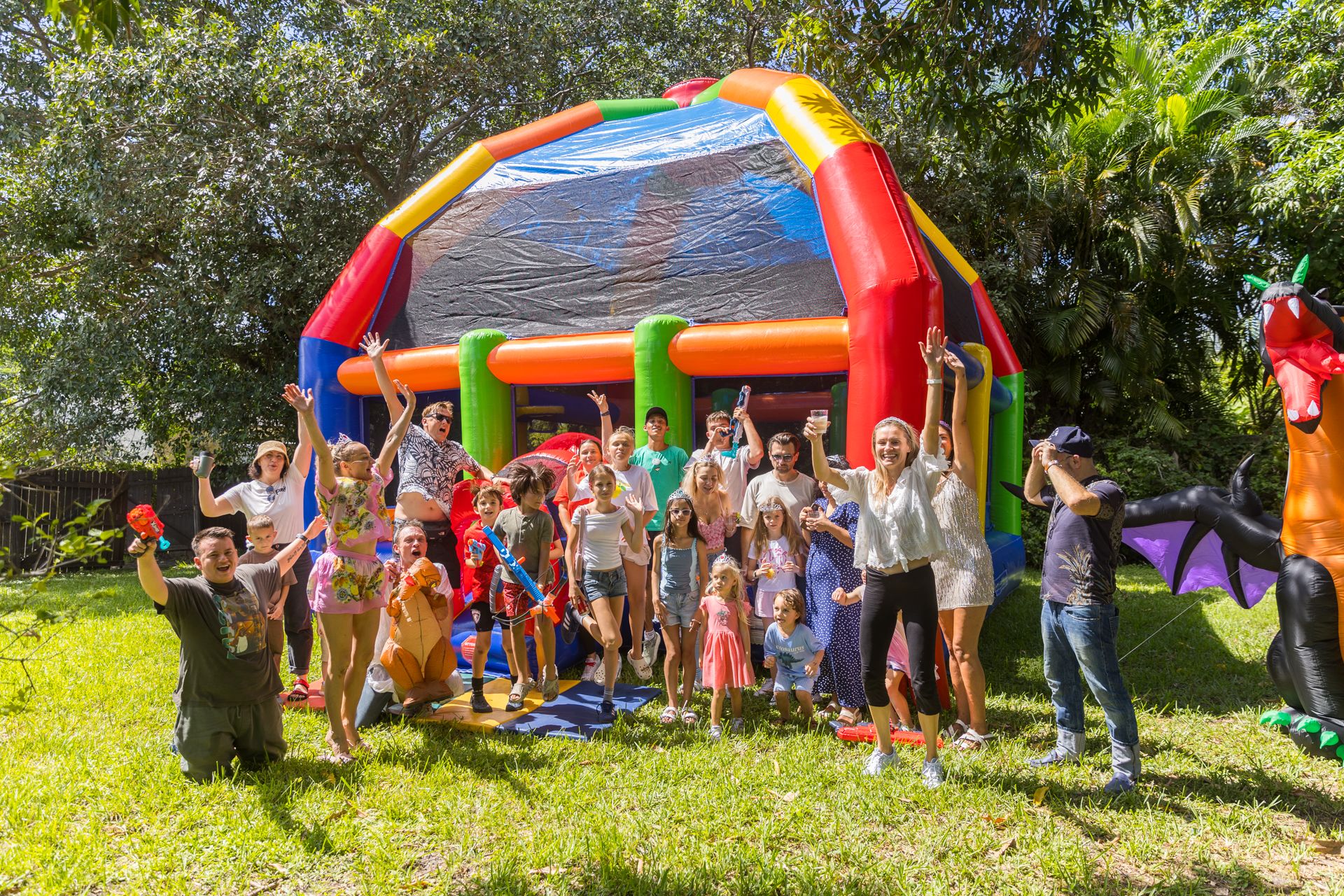 Children and parents cheer in front of the giant inflatable dragon at the finale